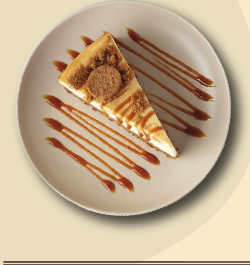 Slice of cheesecake drizzled with caramel