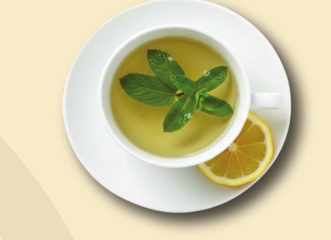 Cup of green tea with fresh mint leaves and lemon